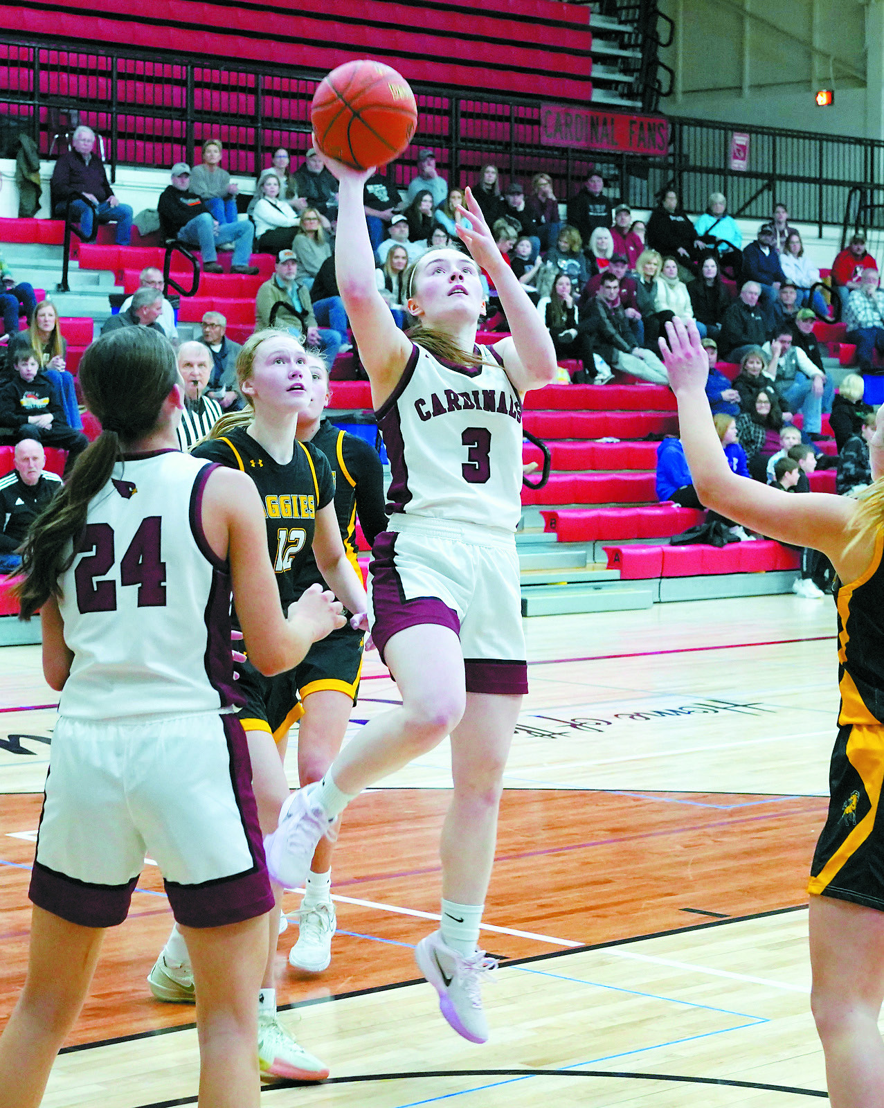 Player of the Game Merideth Romfo lays in her 1,000th Career point on Jan. 28 in the Cards' home game win over Park River. Photo by Larry Stokke.