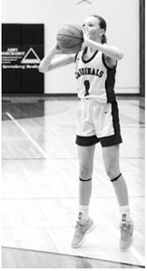 Ary Schaefer eyes the basket and drops the ball in the hole for three points. Photo by Larry Stokke