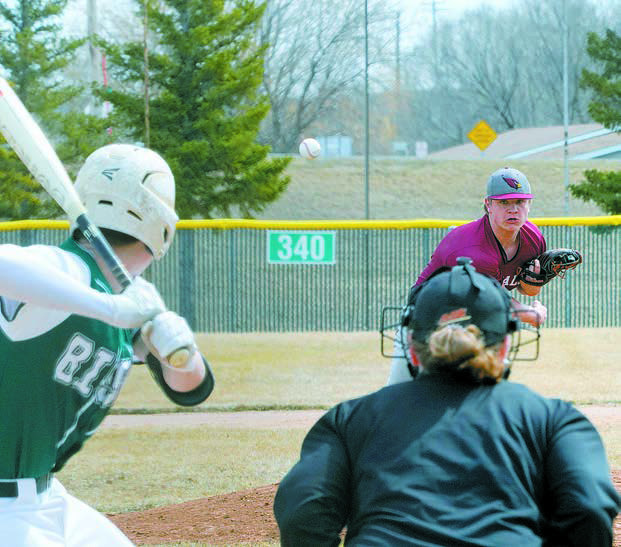 Theo Romfo fires a strike past the Hazen Bison batter. Photo by Larry Stokke.