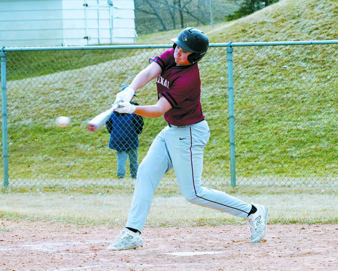 Landon Schneider with a base hit against Beulah. Photo by Larry Stokke.