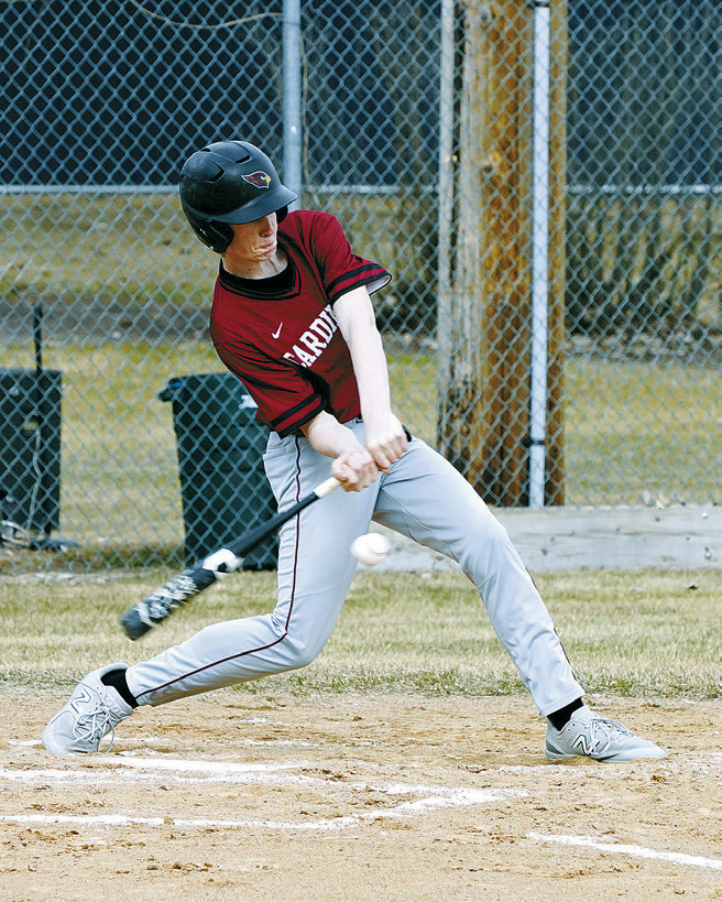 Tyson Gemmill makes contact with the ball for a base hit in the Cards' win over Bottineau. Photo by Larry Stokke.