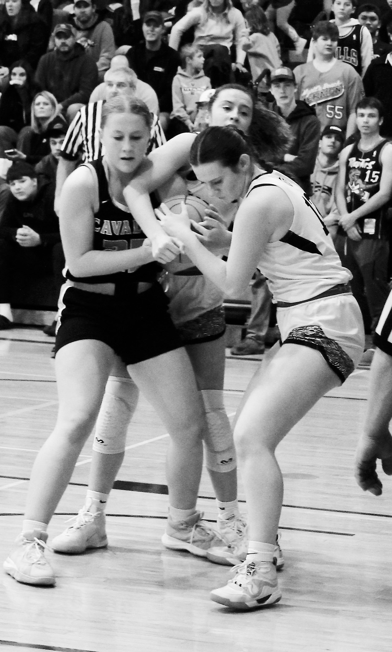 Cavalier's Katy Jensen fights for control of the ball against DVE's Jaelyn Johnson and Ingrid Myrdal. Photo by Jamie Rarick.
