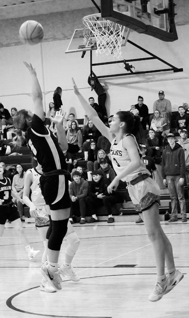 Cavalier's Emma Seng goes for the shot against DVE's Rosalyn Fedje. Photo by Jamie Rarick.