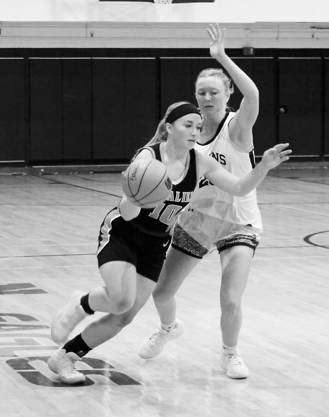 DVE's Peyton Larson defends Cavalier's Sara Jensen as she drives the ball towards the basket. Photo by Jamie Rarick.