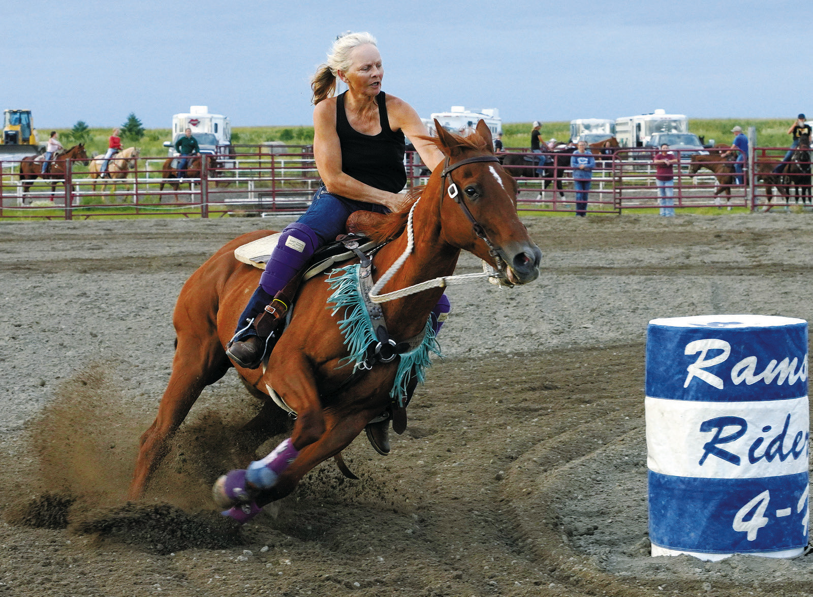 Maddi Knoke took 3rd place in the first open 4D on her horse Shooter. Photo by Larry Stokke. Cyndi Hummel on BLR Balto, aka June, won the first open 3D. June is a 26.5 year old mare, with her rider Cyndi, who is 55, and a grandmother. June is Cyndi's daughter's semi-retired barrel horse, and neither rider nor horse are prepared to completely leave the barrel world anytime soon! Photo by Larry Stokke.