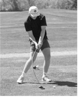 Langdon Area/Munich golfer Korbyn Rollness swings through a shot during regional golf competition. Photo by Larry Stokke