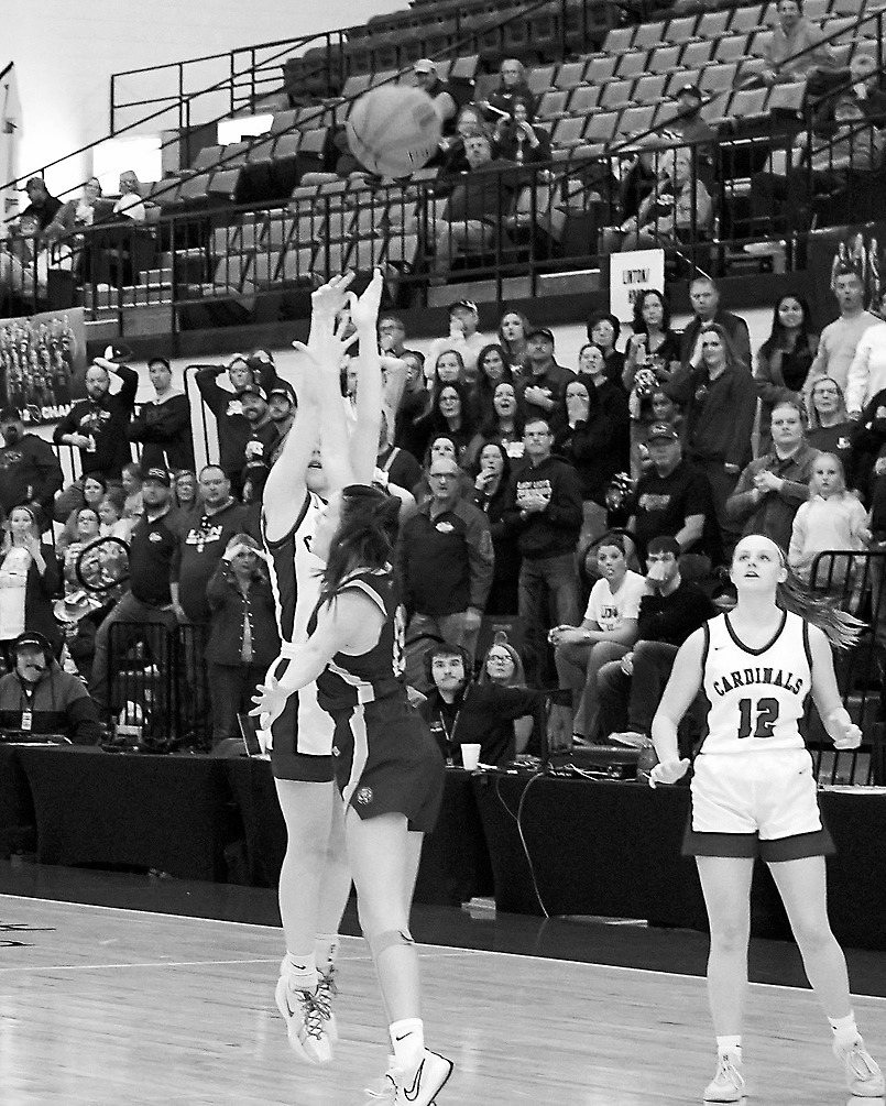With seconds left, Hilary Haaven nails a long 3-point shot to win the game and secure 5th place for the Cards at the state tournament. Photo by Larry Stokke.