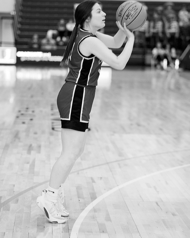Erika Bakke drains a 3-point shot against the Cougars and was Player of the Game against Central-Mclean. Photo by Larry Stokke.