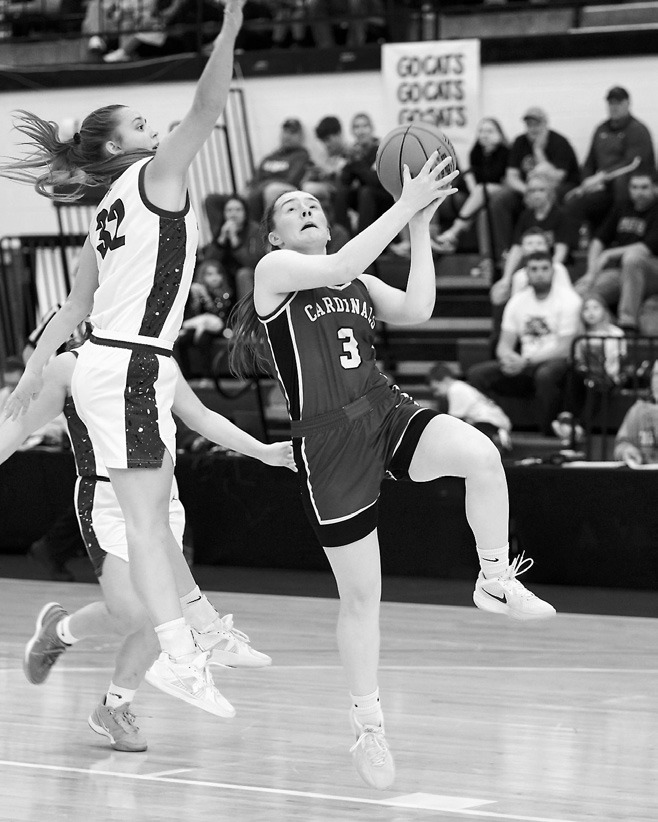 Meredith Romfo lays in a basket, finishing with a game high of 27 points against Grant County. Photo by Larry Stokke.
