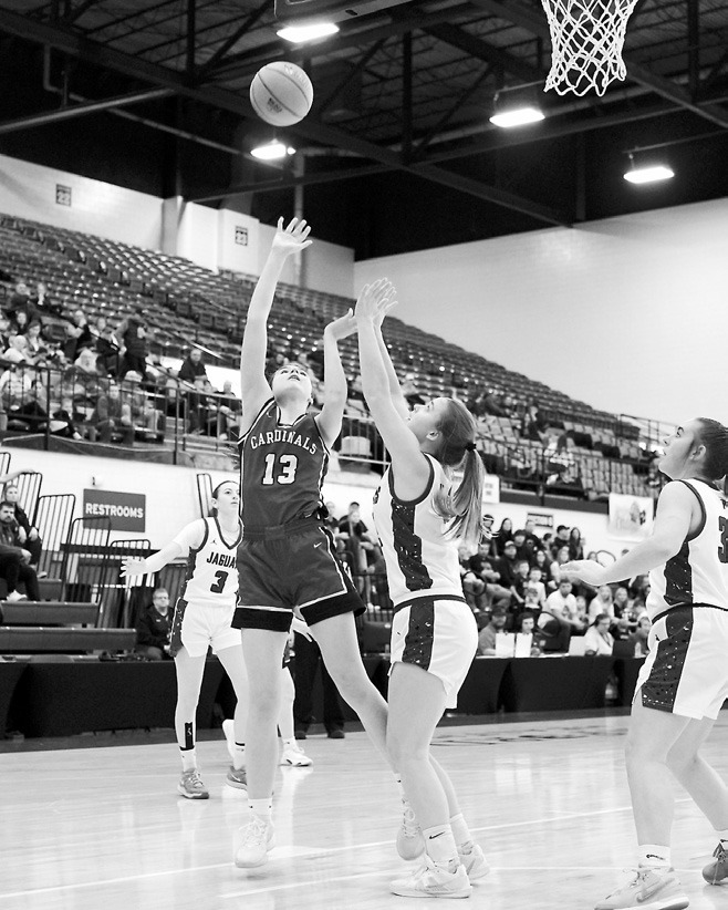 Taya Feist adds 2 points to the Cards' score. Photo by Larry Stokke.