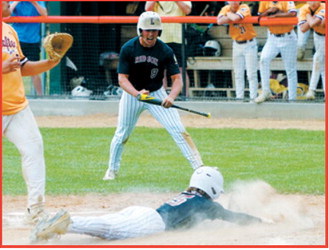 Connor Mitchell slides safely into home plate as teammate Dawson Downs cheers him on. Photo by Larry Stokke