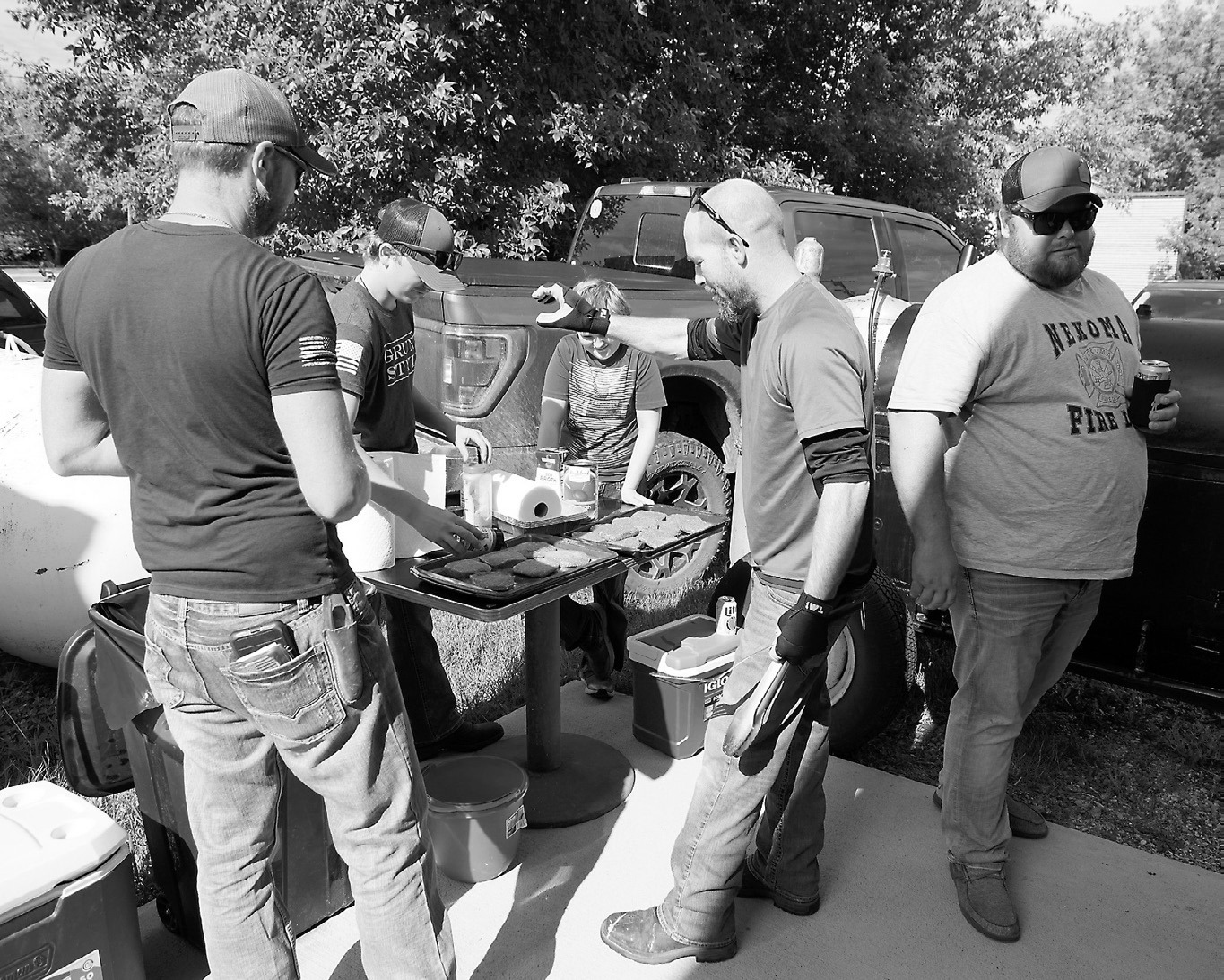 The boys grilling up Langdon Locker burgers and brats.