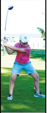 A young golfer tees off during the St. Alphonsus School Adult-Child Golf Tournament on July 13 at the Langdon Country Club. Photo by Larry Stokke