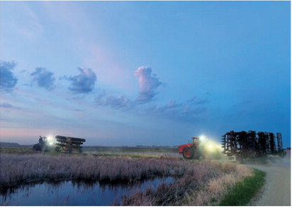 The workday doesn't always end at sunset. Tractors and field equipment make their way down a rural road under the evening sky as area farmers take advantage of favorable conditions to keep spring fieldwork moving. Submitted photo