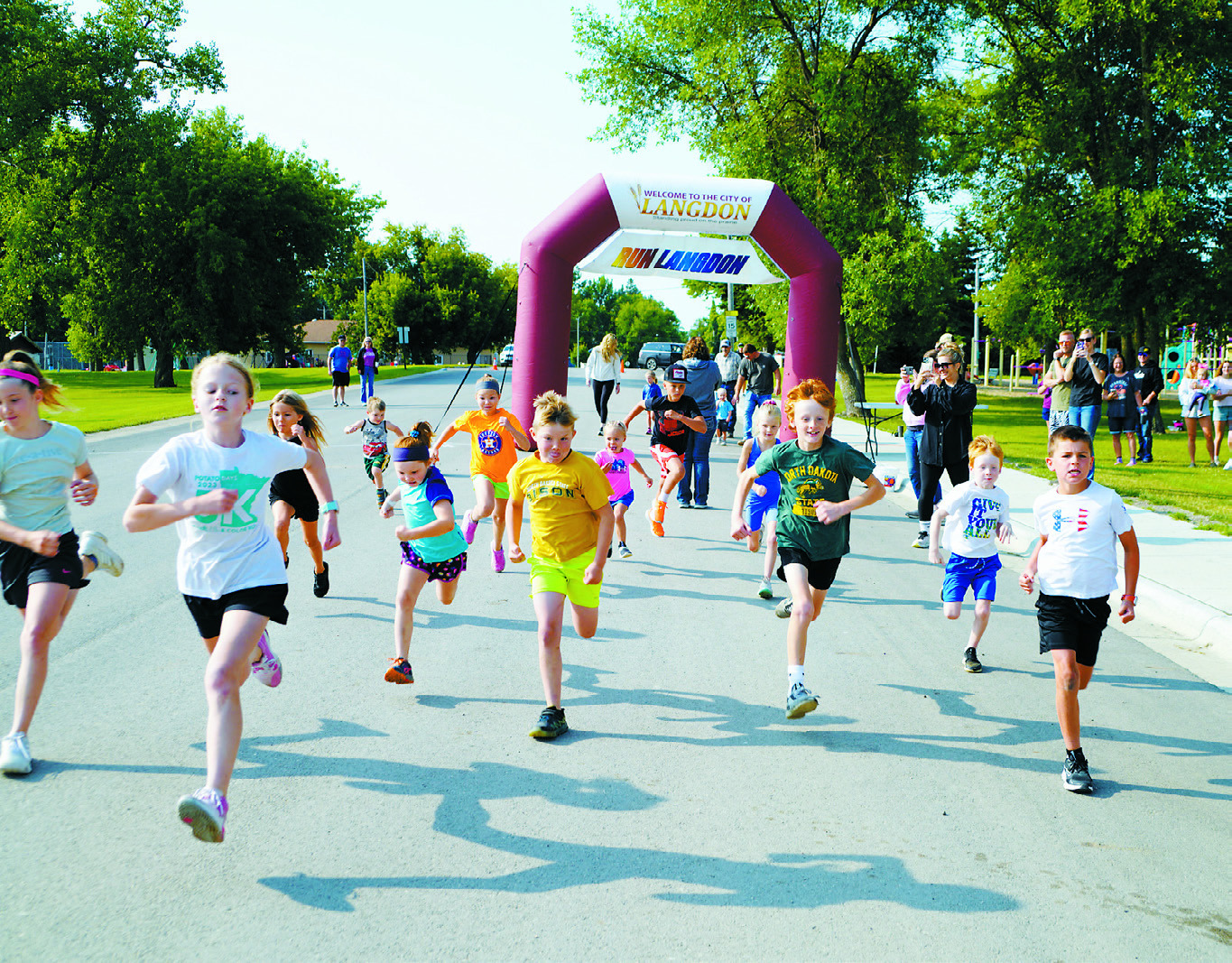Bianca Chaput gives it her all in the pedal pull Kiddos take off at the starting line of the Run Langdon 5K. Photo by Larry Stokke. competition on Saturday during Music Fest. Photo by Larry Stokke