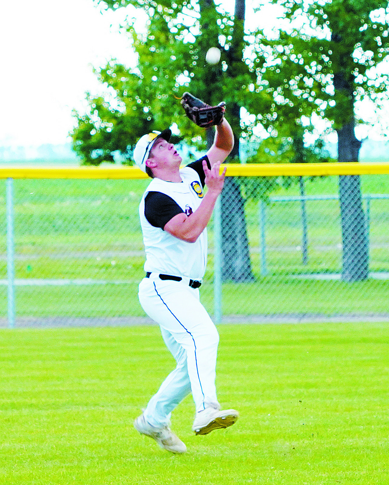 Theo Romfo catches a deep fly ball against Grafton on July 8. Photo by Larry Stokke.
