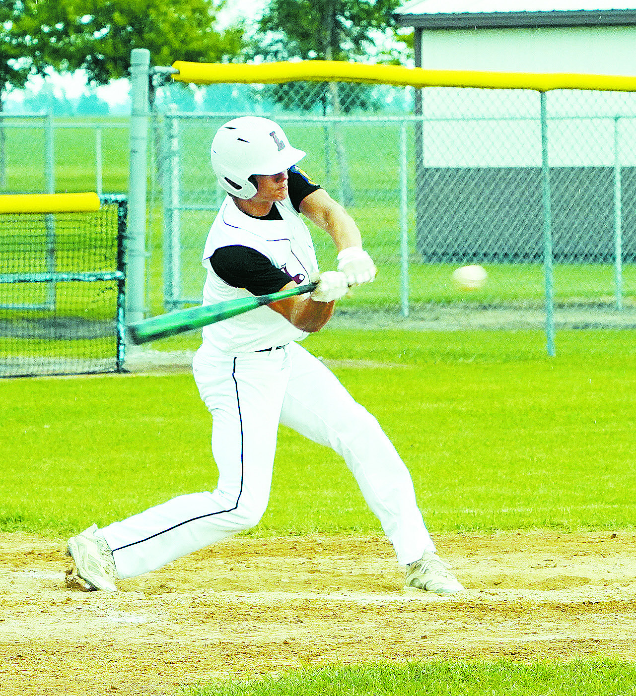 Nick Kingzett gets a base hit against Grafton. Photo by Larry Stokke.