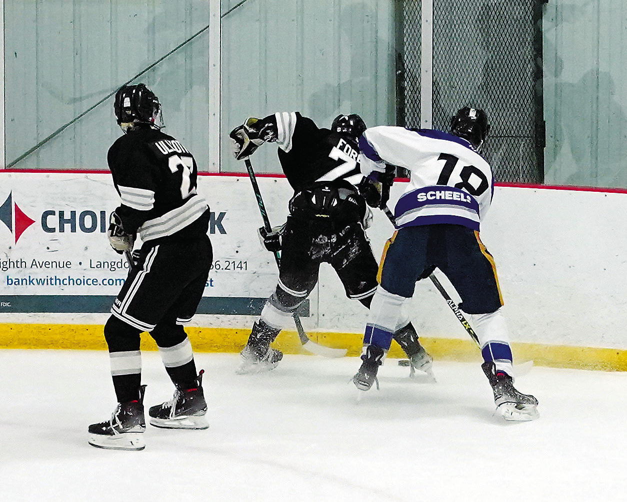 Kennen Forest fights for control of the puck at the Dakota Spirit Arena on Dec. 13 when the Blades beat Fargo. Photo by Larry Stokke.