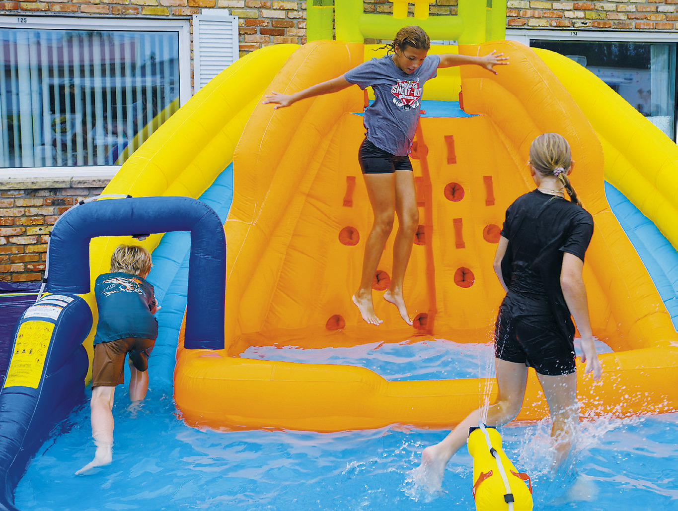 The inflatable splash park stole the show and kept kids at play for hours last Thursday at Maple Manor. Photo by Larry Stokke.