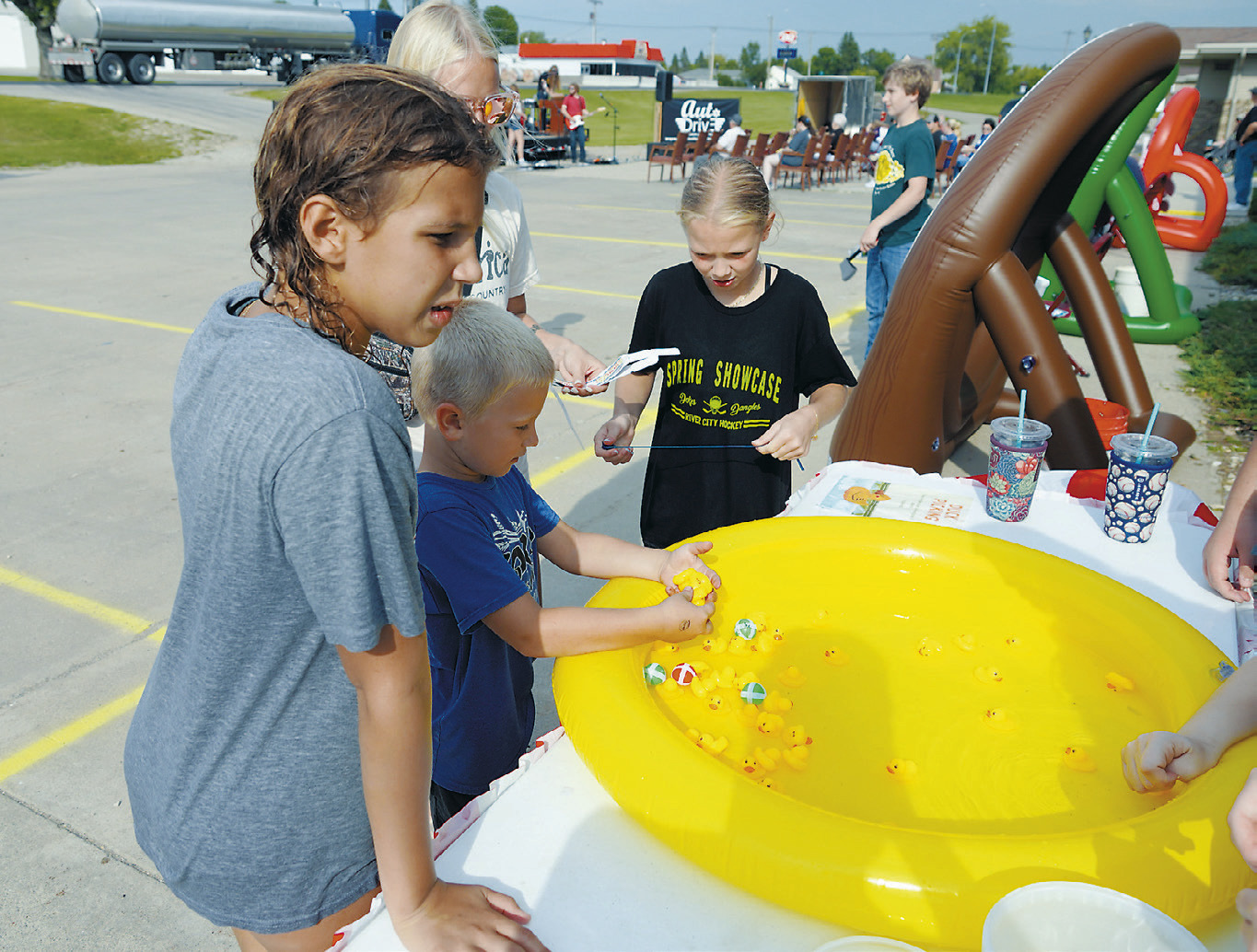 Kids enjoy fishing for rubber duckies to win prizes at the Maple Manor Carnival last week. Photo by Larry Stokke.