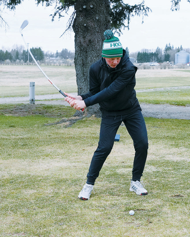 Korbyn Rollness watches his drive off the tee during the Dave Osborn Invitational in Cando on May 5. Photo by Larry Stokke