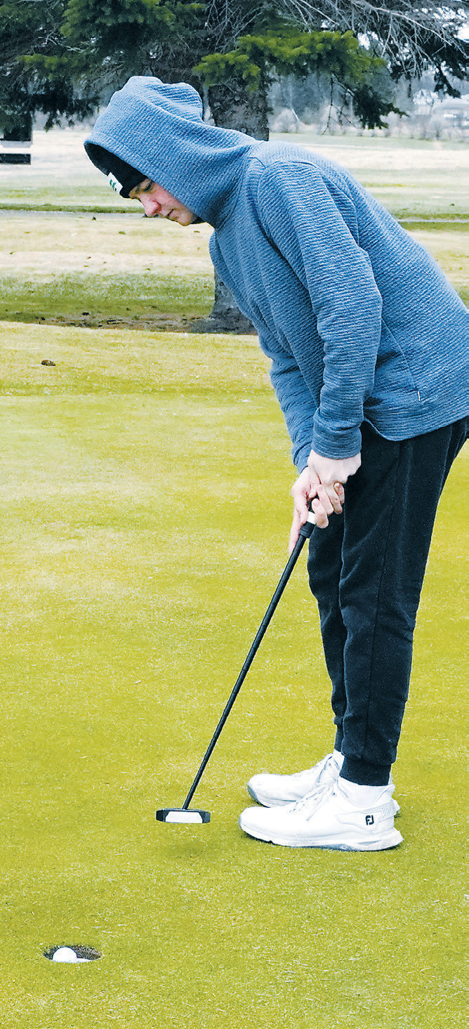 Kennen Forest sinks a putt during the Dave Osborn Invitational in Cando on May 5. Photo by Larry Stokke