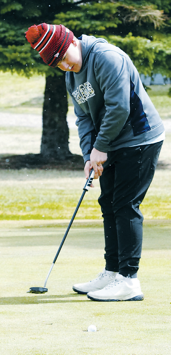 Baylor Tryan lines up a putt during the Dave Osborn Invitational in Cando on May 5. Photo by Larry Stokke