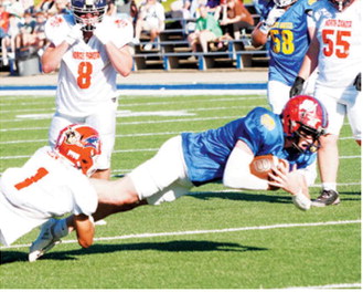 Jax Johnson dives for a first down for the East 11-man team during its victory over the West team in the Shrine Bowl in Mayville on June 20. Photo by Larry Stokke