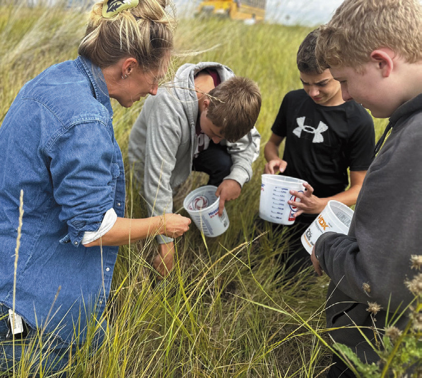 Artist Austen Camille [left] along with North Valley CTE students Aaron Linner, Kale Tanke, and James Elliott collecting prairie soils they later rendered into paint pigments during the Thinking Like a Prairie workshops. Photo provided by Josh Anderson.