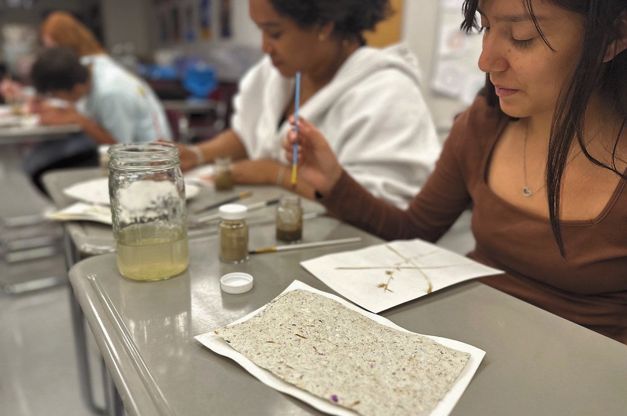 Students Julissa Garcia and Daphneiris Almonte from the North Valley CTE program paint on prairie paper with pigments made from local soils as part of the Thinking Like a Prairie workshops. Photo Josh Anderson.