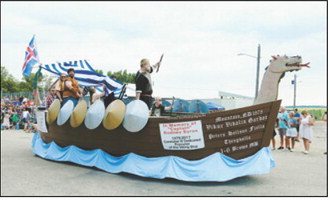 A Viking ship float honoring the late “Captain” Rodney Byron makes its way through Mountain during the Deuce of August parade. Photo by Larry Stokke
