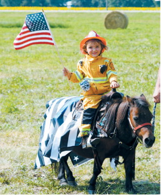 Lyla Gullickson, dressed as a firefighter, took first place in the Best Costume Class during Mountain’s 127th Deuce of August celebration. Photo by Larry Stokke