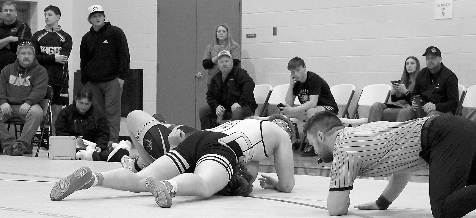 Denton Kaercher took only one minute and 30 seconds to pin his man, punching his ticket to the state tournament. Photo by Larry Stokke.