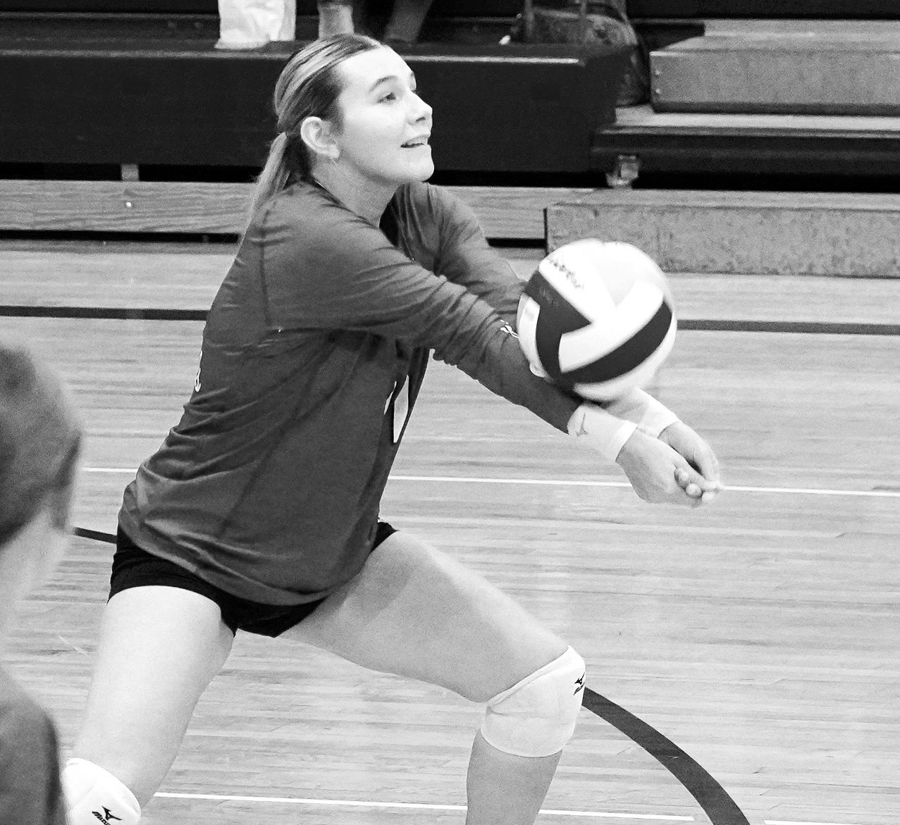 Raeleigh Ratzlaff digs the ball from the back row against the Eagles. Photo by Larry Stokke.