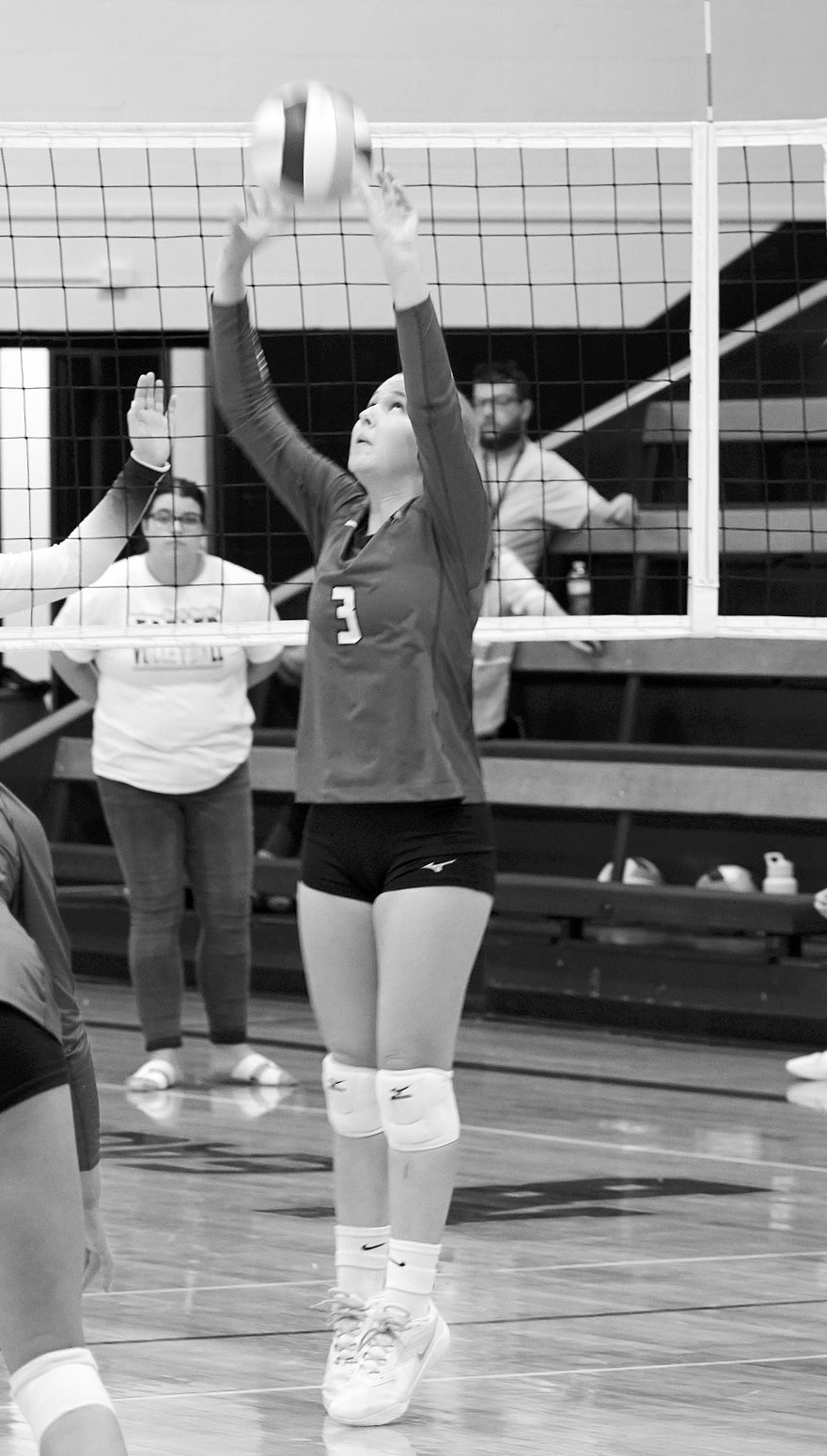 Cardinal Payton Hall eyes the ball and sets it to a teammate in the game against the Eagles. Photo by Larry Stokke.
