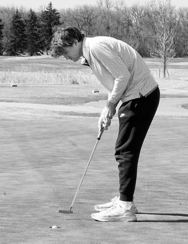 Keaton Ullyott sinks a putt at Creel Bay in Devils Lake on April 29 where he finished the day with 91, putting him in a three-way tie for 26th place. Photo by Larry Stokke.
