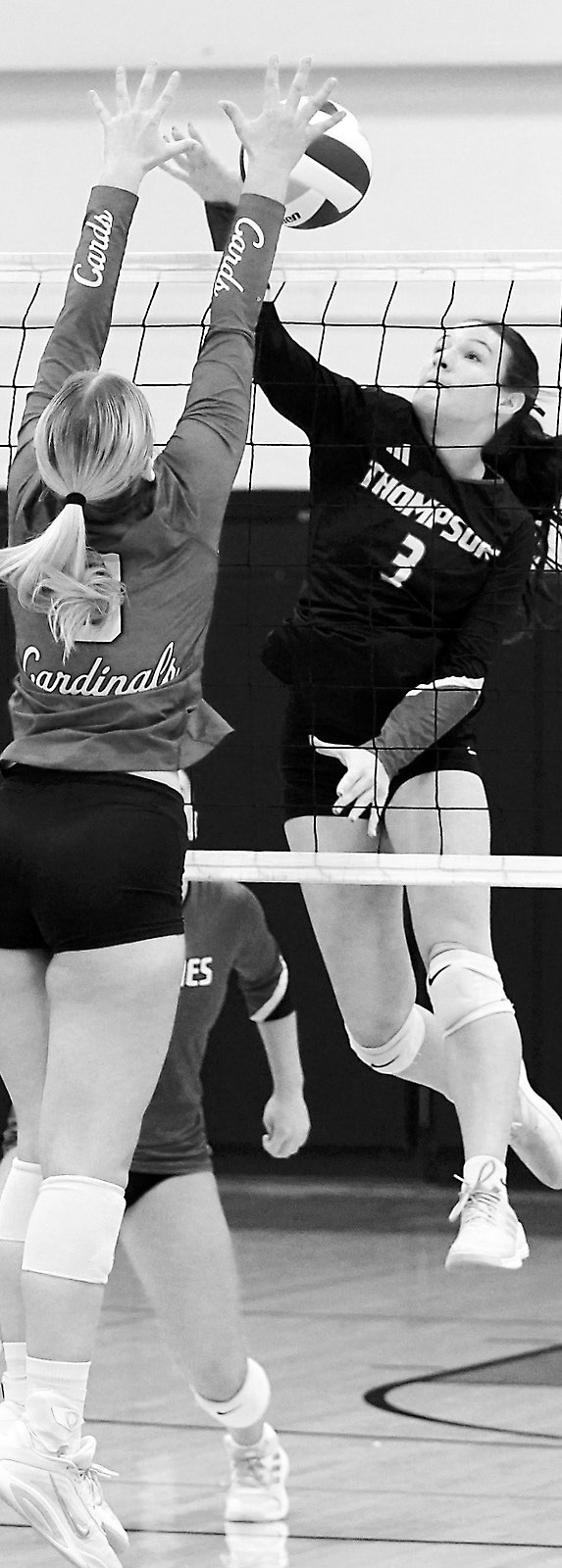 Emma Hall stuff blocks her opponent in the Cards' win over Thompson. Photo by Larry Stokke.