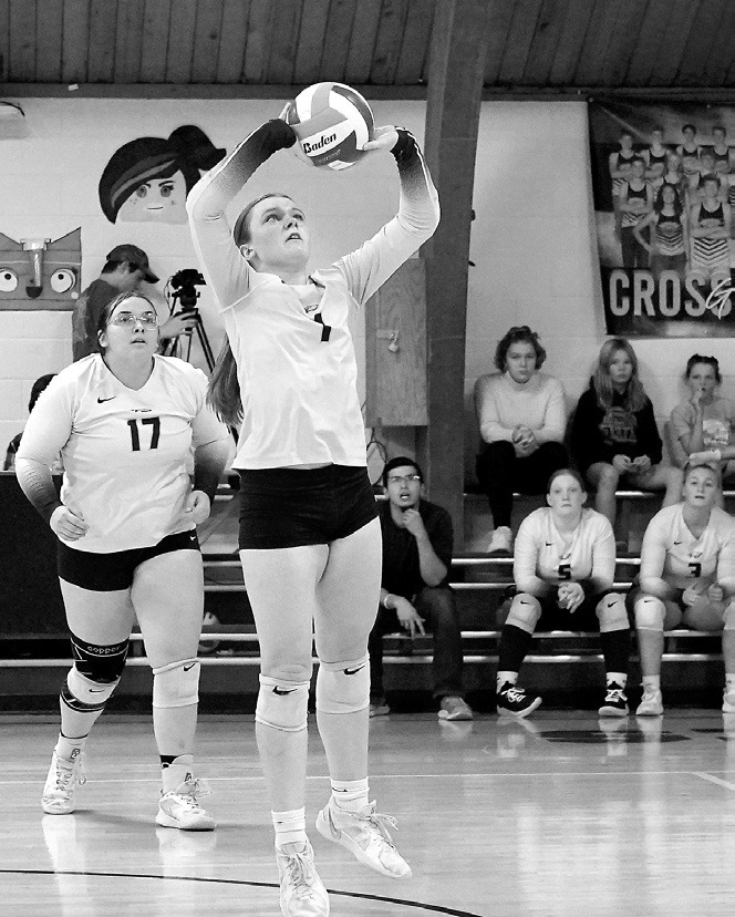 Hanah Moore sets the ball high for a teammate in Pembina on Oct. 23. Photo by Larry Stokke.