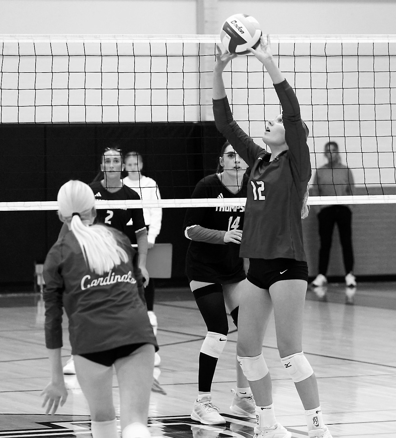 FM State Bank's Player of the Game Kemi Morstad sets the ball to a teammate in the Cards' sweep of Thompson on Oct. 25. Photo by Larry Stokke.