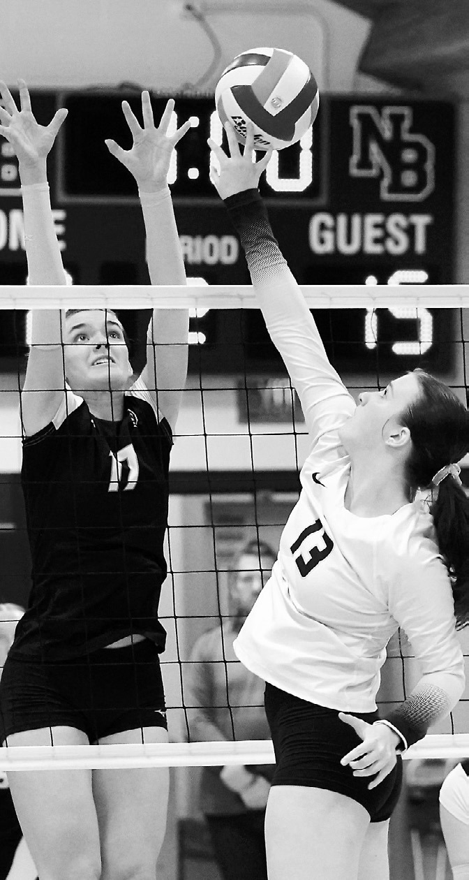 Addison Lyons with one of her four kills against the DVE Titans. Photo by Larry Stokke.