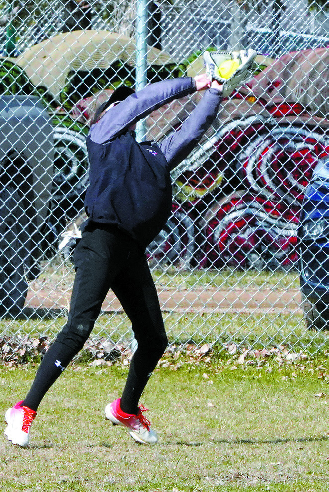 Lily Zimmer with a great catch deep in center field in Carrington on April 22. Photo by Larry Stokke.