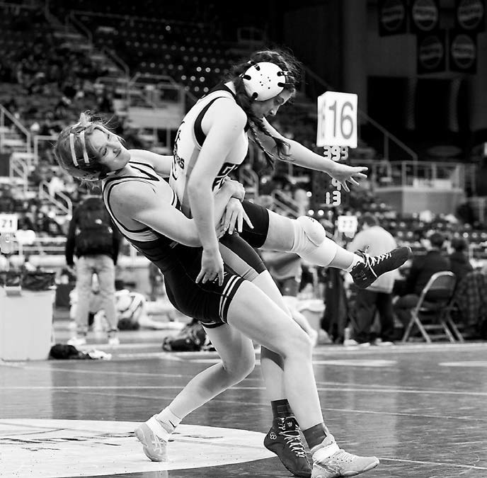 Marlie Stremick in the 124 lb. weight class takes her opponent for a quick pin in Fargo on Jan 2. Photo by Larry Stokke.