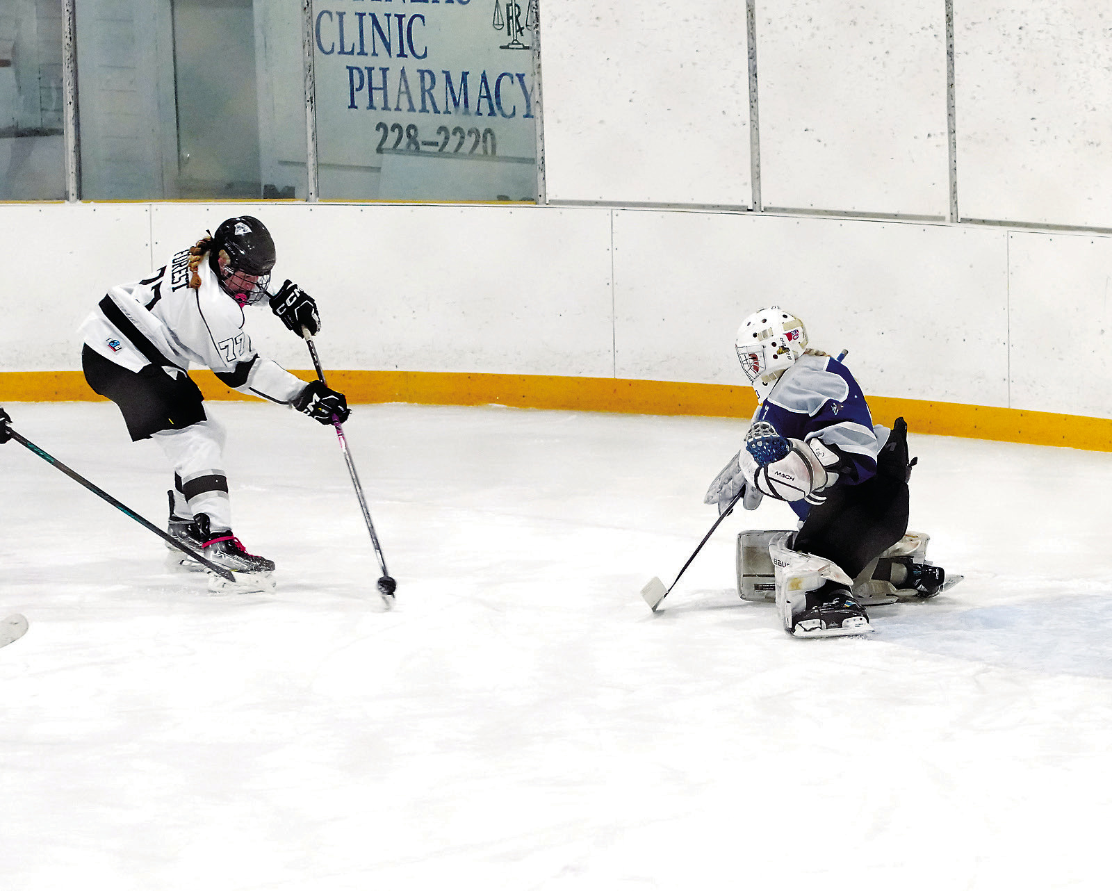 Colby Forest skates in and fires off a shot, trying to get around the goalie in Bottineau on Saturday, Dec. 6. Photo by Larry Stokke.