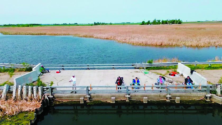 The Nowatzki ‘kids’ set up chairs and rod holders on old 281 near Churchs Ferry for their frequent fishing trips to Devils Lake. There were 11 children in the family and all loved to fish. The oldest is now 87. Photo by Abby Makay / WDAY News.