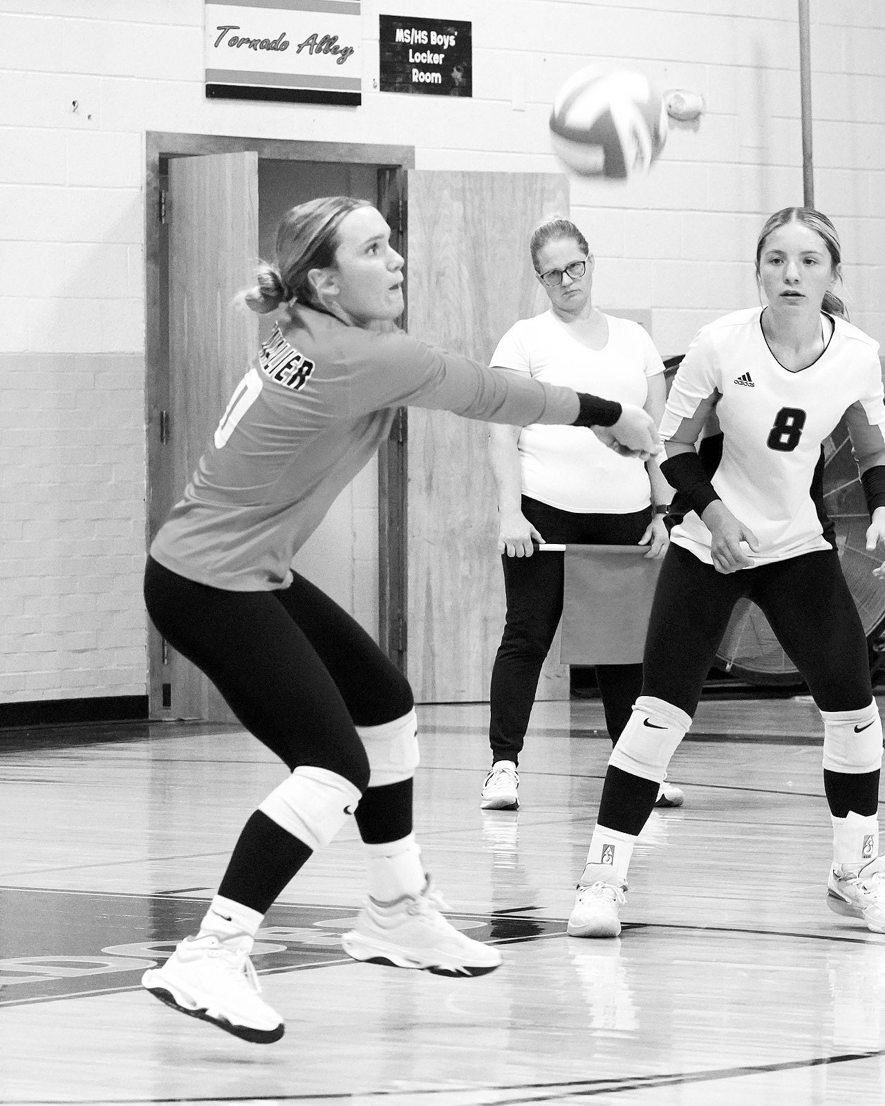 Remi Larson digs the ball and sends it to the front row. Photo by Larry Stokke.