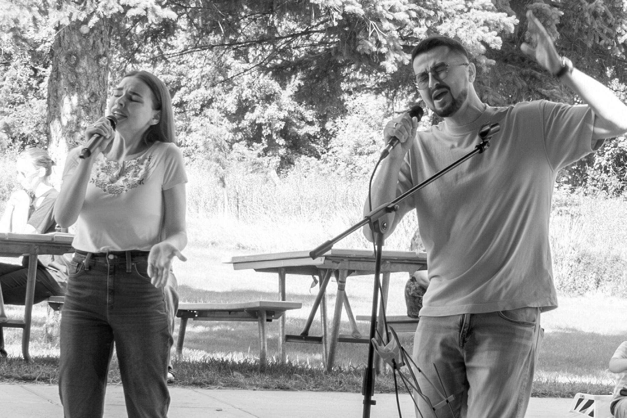 Dmytro Somkin, right, and Kseniia Somkina entertain the crowd with a Ukrainian song during the FM Volunteers for Ukraine International Day of Peace fundraiser in Moorhead, Minnesota, on Sept. 21, 2025. (Photo by W. Scott Olsen/For the North Dakota Monitor)