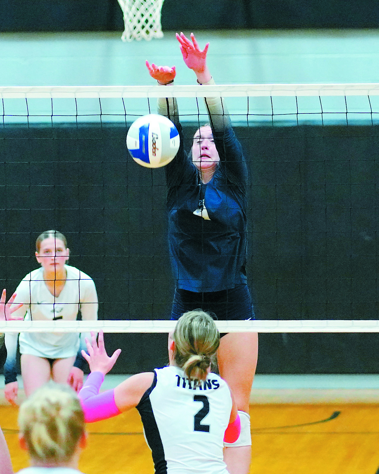 Jaelyn Johnson with a stuff block in their five set game in Crystal on Oct. 13. Photo by Larry Stokke.