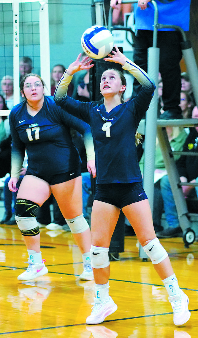 Adrienne Longtin sets the ball to her teammate in the game against DVE in Crystal. Photo by Larry Stokke.