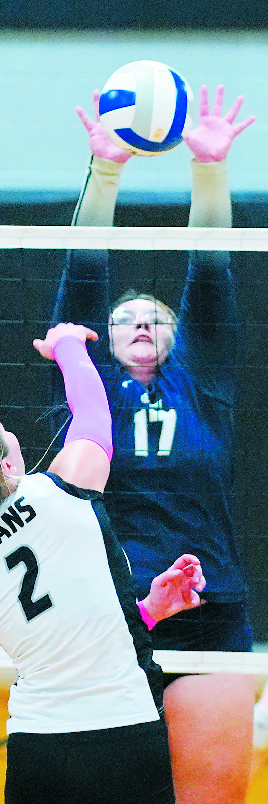 Jaelyn Forrey stuff blocks the ball in the game against the Titans. Photo by Larry Stokke.