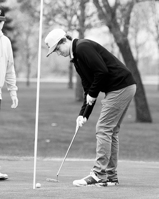 Tyler Kram sinks a putt at the Larimore Golf Meet and finished with a score of 95. Photo by Larry Stokke.